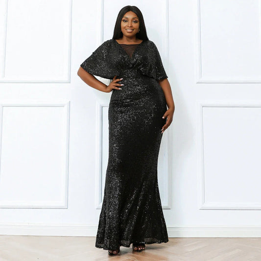 Woman wearing plus size black sequined evening dress