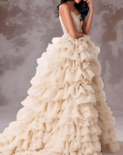 Detail of beige champagne tiered tulle skirt on formal prom dress