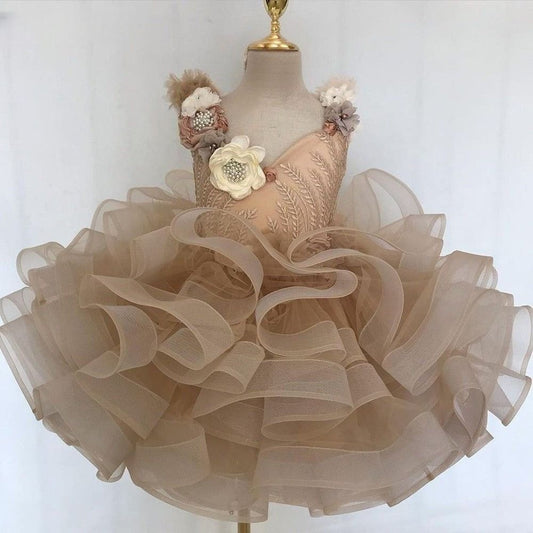 Aria Champagne Tulle Mini Flower Girl Dress. Adorned with delicate 3D flowers and whimsical ruffles