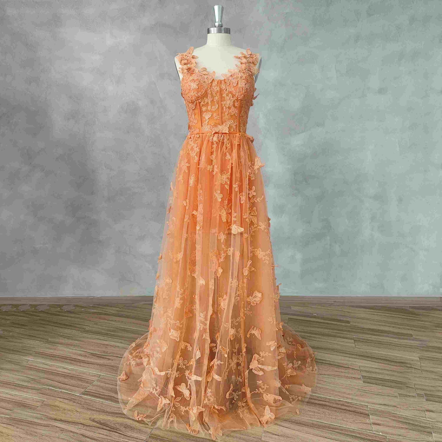 Elegant orange A-line dress with 3D butterfly lace, perfect for prom or formal occasions.