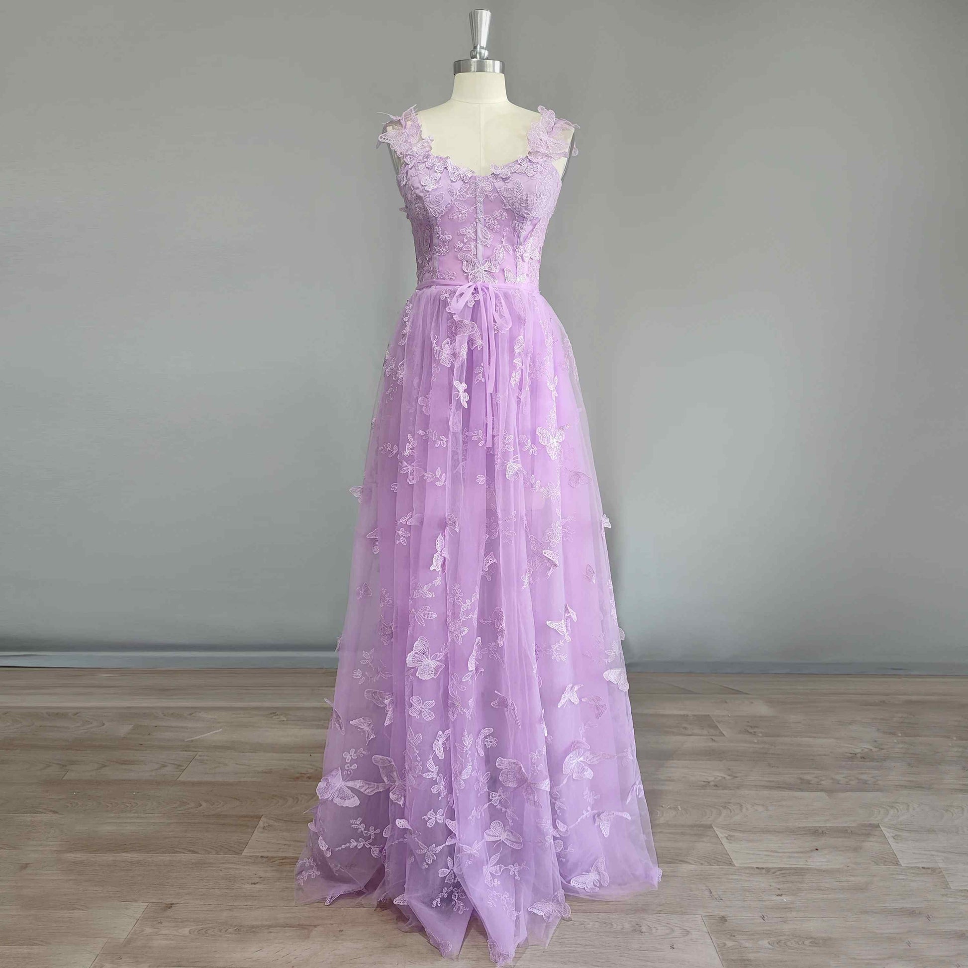 Stunning purple prom gown with 3D butterfly appliques, sleeveless design, and A-line silhouette.