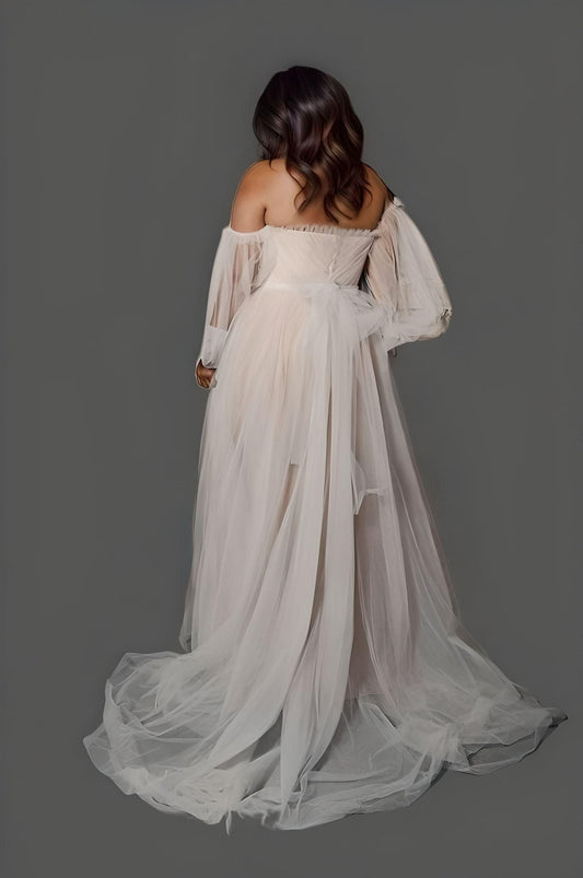 Bride from back in wedding dress with long puff sleeves, pleated ruched decorations, back bow and a sweep/brush train.