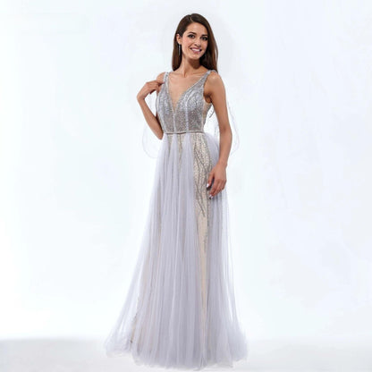 Woman wearing a silver evening gown with sparkling beaded bodice