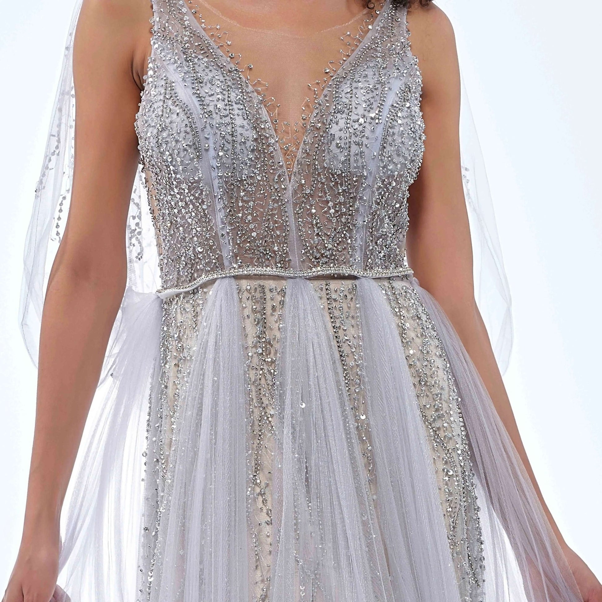 Detail of silver beading bodice on evening gown on a white background