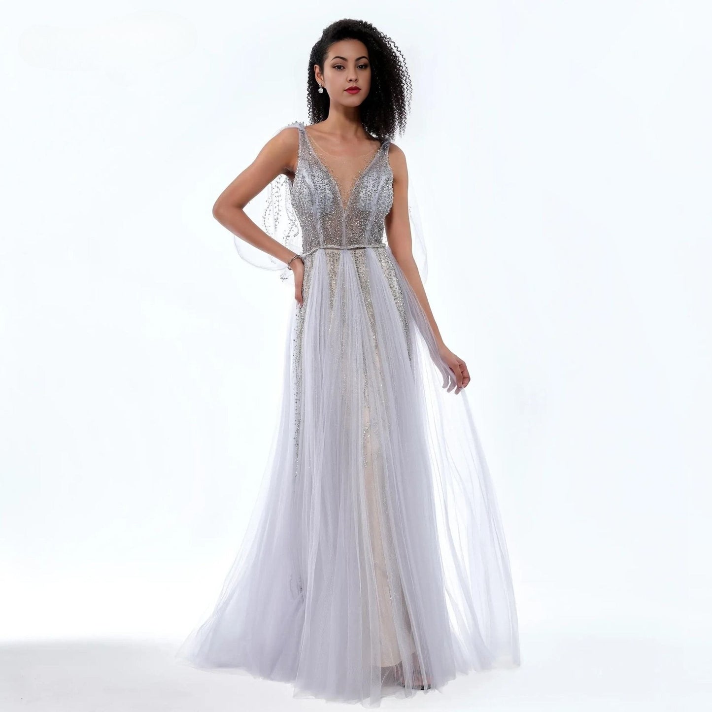 Woman wearing a silver evening gown on a white background