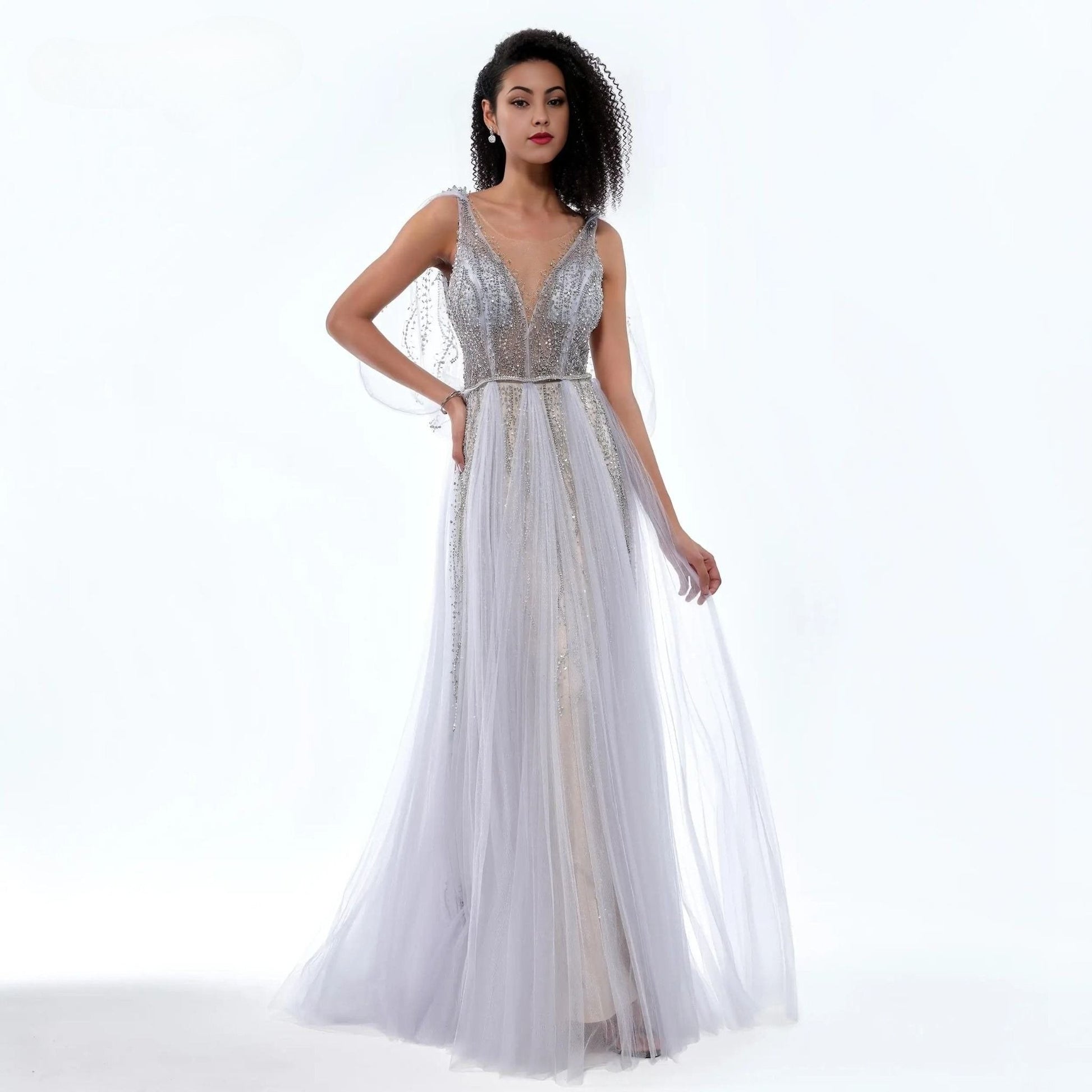 Woman wearing a silver evening gown on a white background
