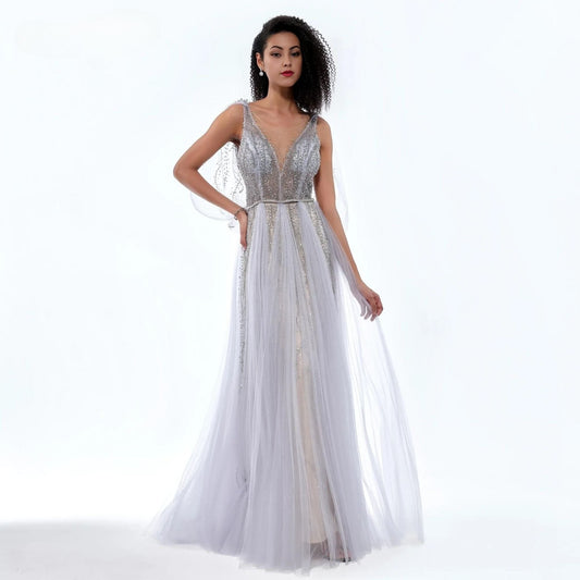 Woman wearing a silver evening gown on a white background
