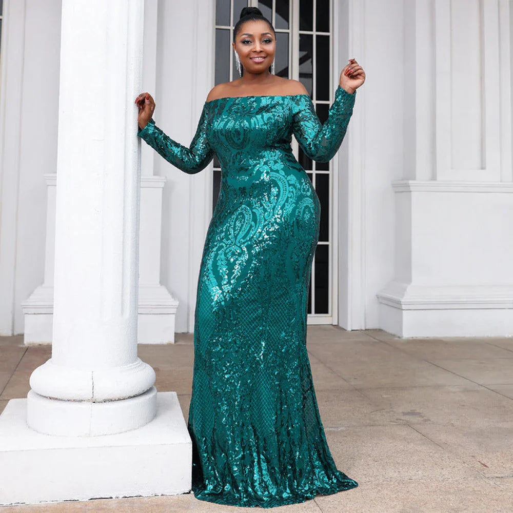 Woman in a stunning emerald green gown with long sleeves, a boat neckline, and intricate sequin detailing, designed for prom and evening occasions.