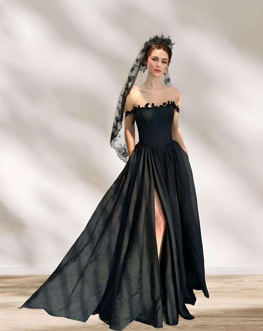 Bride in black wedding dress with high slit wearing black lace veil.