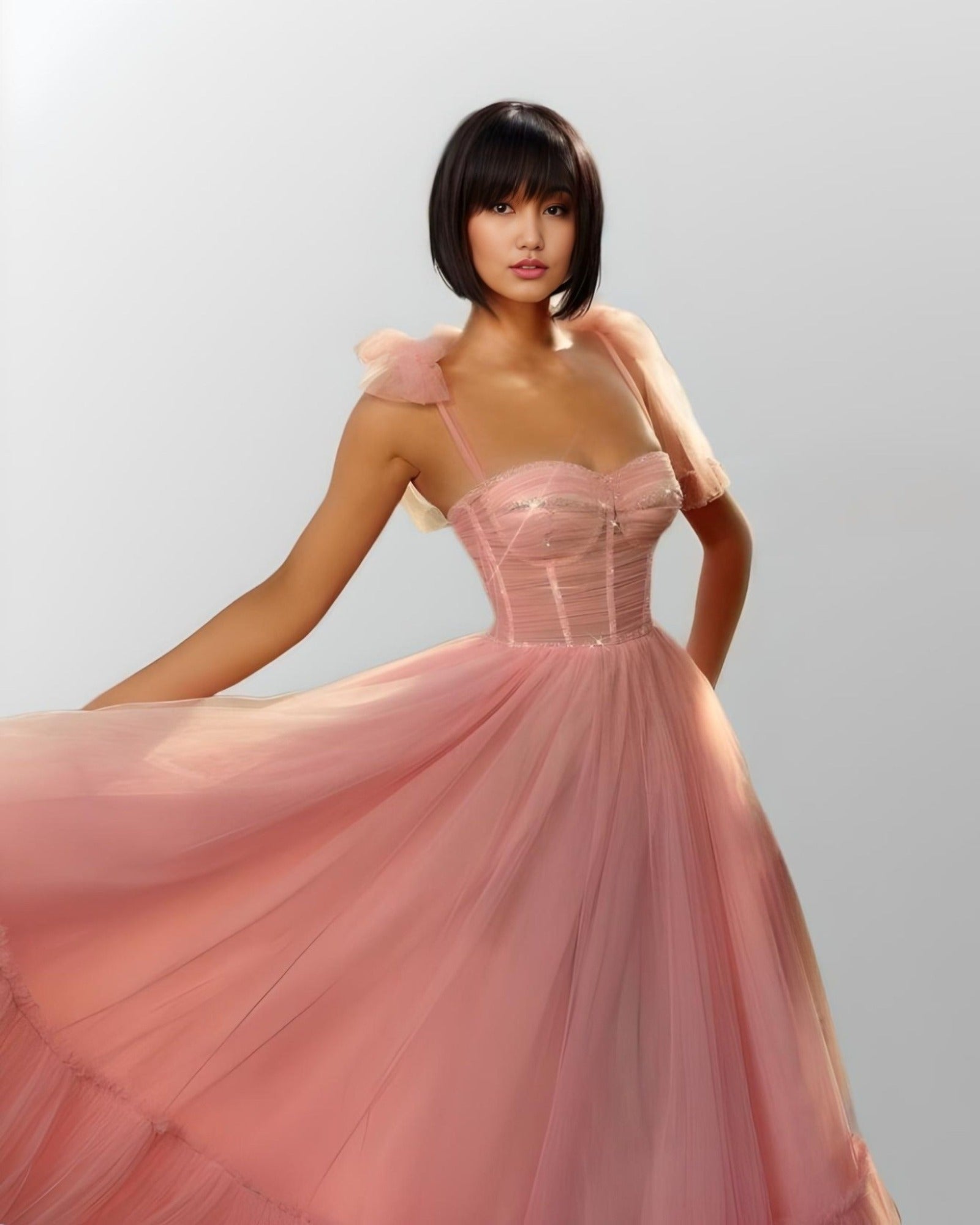 WOman wearing pink LITZY dress with flowing tulle.
