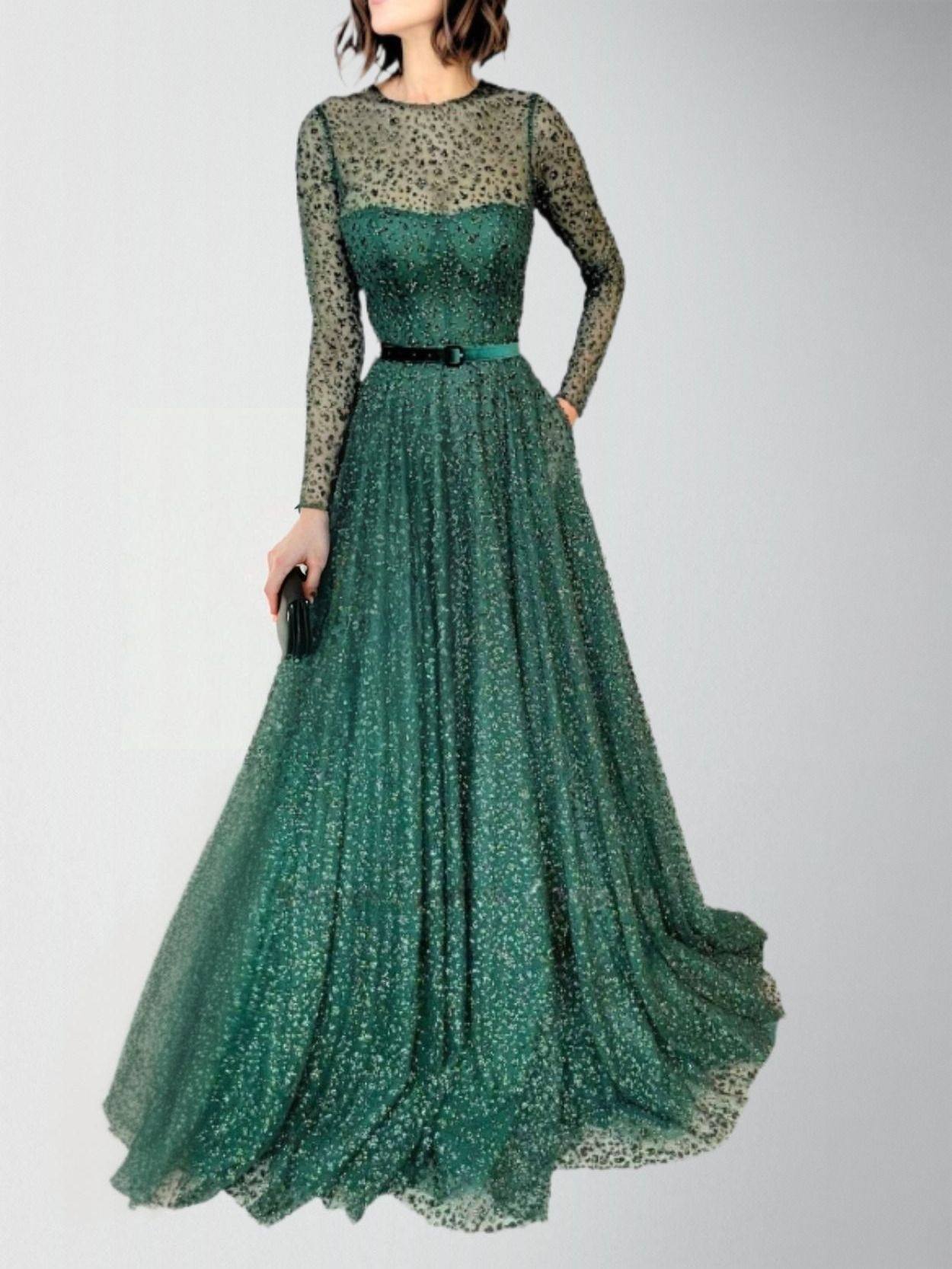 Model in emerald green A-line gown with long sleeves, posing in studio.