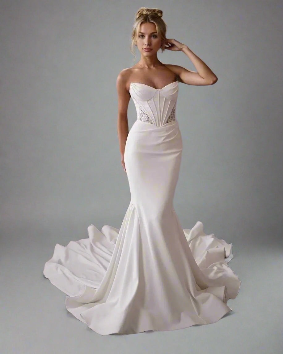 Woman in Oleandra strapless wedding dress with figure-hugging silhouette and sweep train
