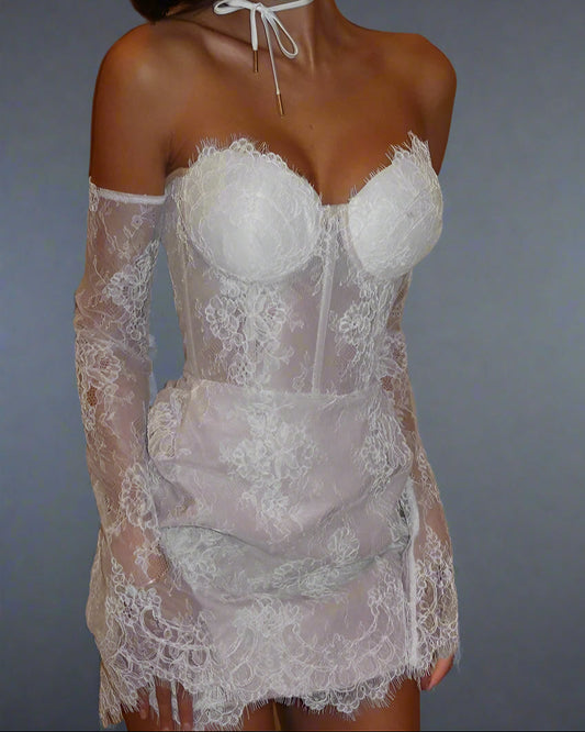 White lace mini dress with long sleeves on a plain background