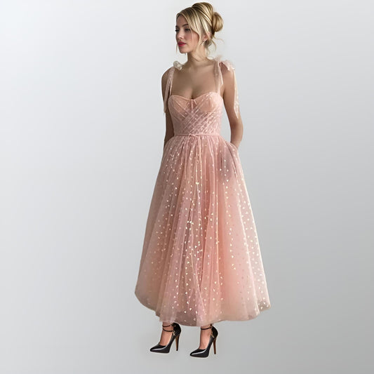 "Woman wearing pink PETRA formal dress with heart tulle design"
