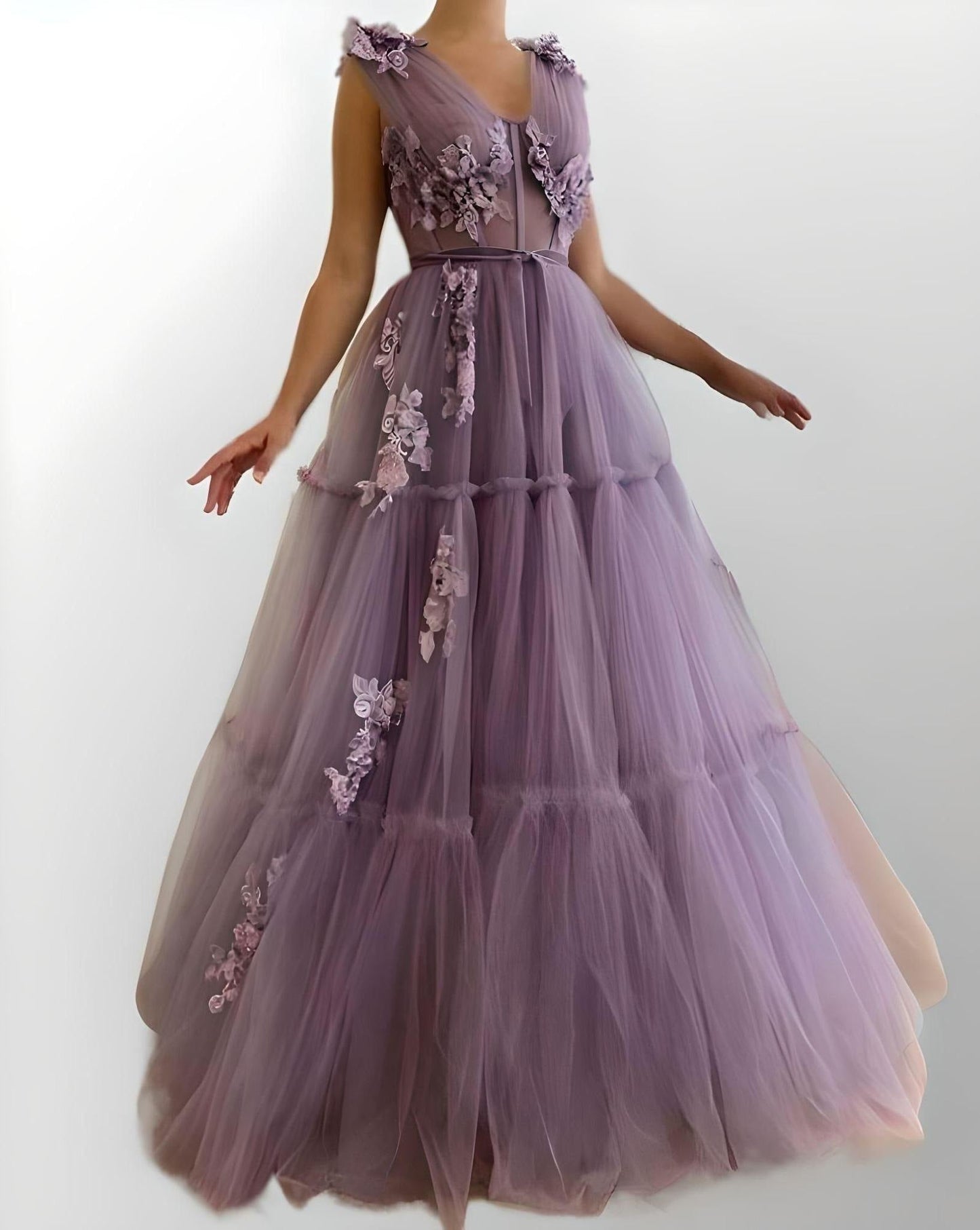 Exquisite tiered tulle formal dress with exposed boning and 3D appliques.