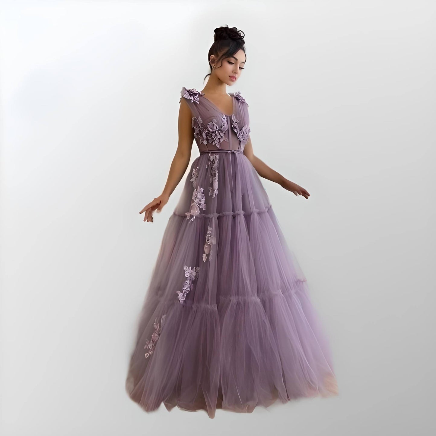 Model wearing RAQUEL purple formal dress with tiered tulle skirt and 3D flower appliques.