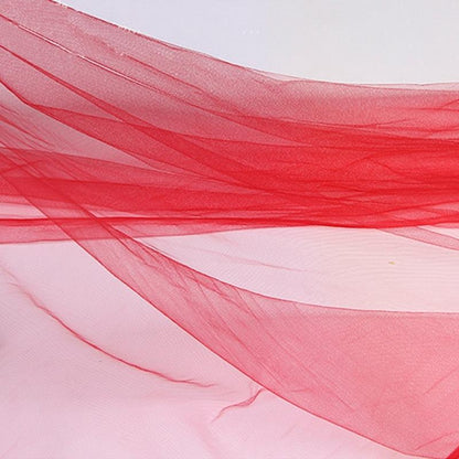 A detailed shot of the red bridal veil against a backdrop, focusing on the striking red hue and classic design.