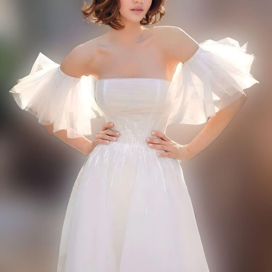 Bride wearing ruffled detachable wedding sleeves.
