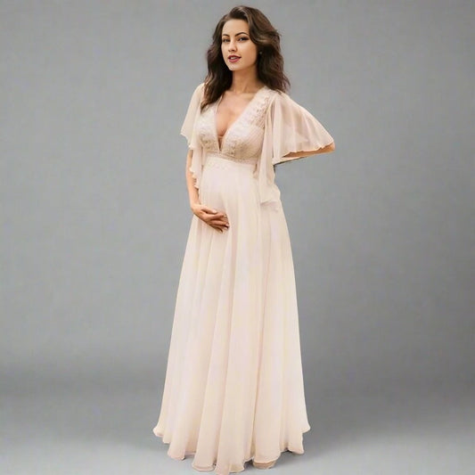 Pregnant bride wearing chiffon Rowan maternity wedding dress with lace top and flowing sleeves.