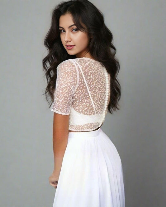 Bride wearing the Sera Two-Piece Wedding Dress showing lace crop top with short sleeves and an open illusion back