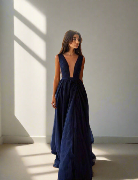 Full-length image of the navy blue SHILOH dress with flowing pleated tulle layers.