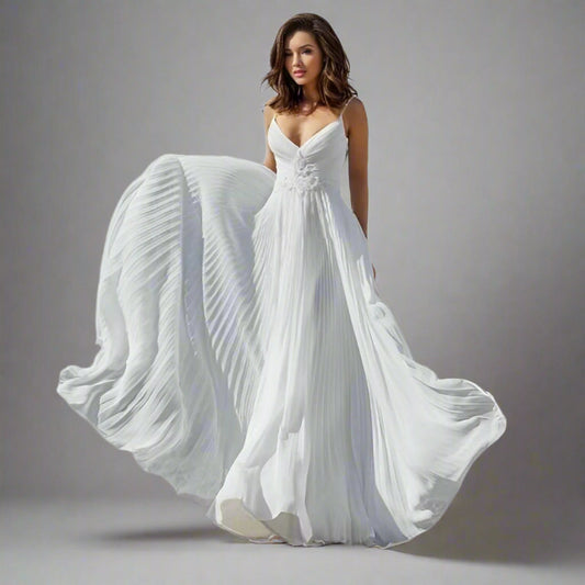 Bride wearing the Shyla Wedding Dress, showcasing its deep V-neck and pleated skirt.