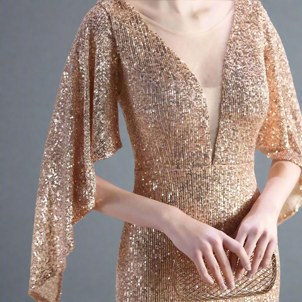 Rose gold sequin evening dress worn by a model holding a clutch