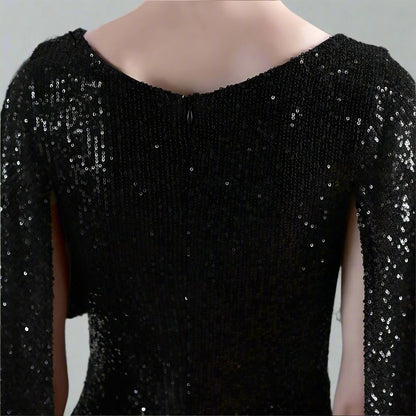 Black sequin dress details against a neutral background