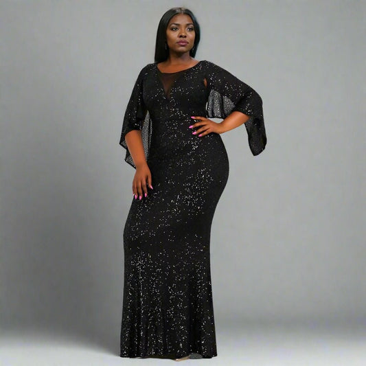 Model showcasing the Stacey Plus Size Formal Dress with cape sleeves and shimmering sequins.