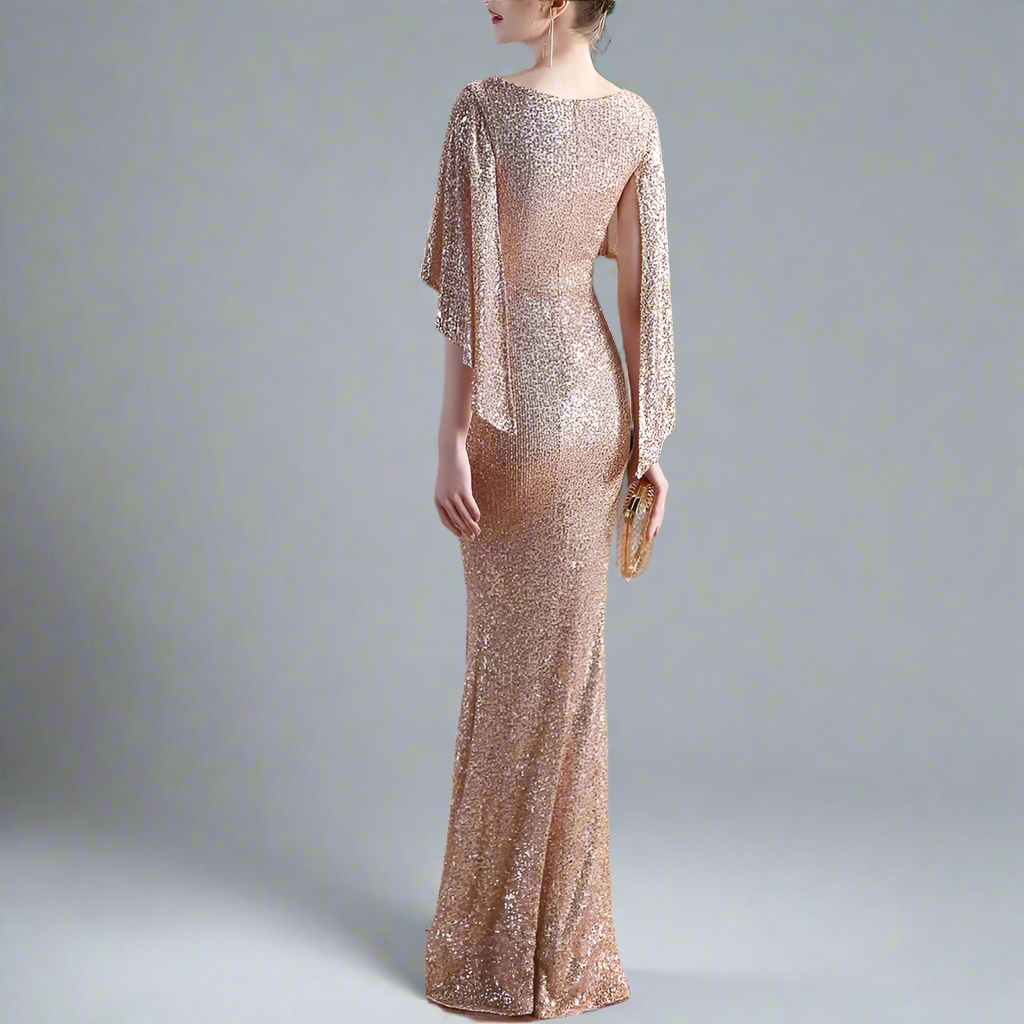 Woman wearing a sparkly gold dress with a blurred background