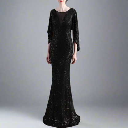 Woman wearing a black sequin evening gown with a blurred background
