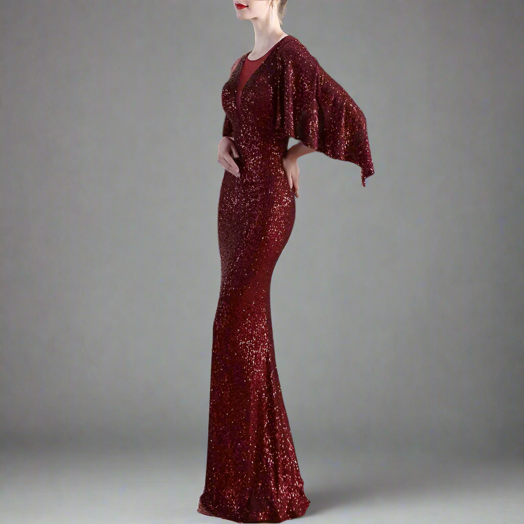 Woman wearing a burgundy sequined shiny mermaid evening dress.