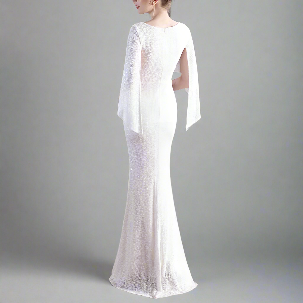 Fully sequined white evening gown with sheer sleeves.