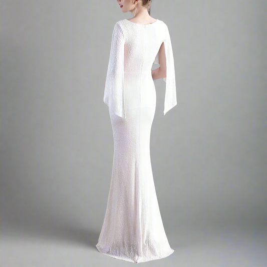 Fully sequined white evening gown with sheer sleeves.