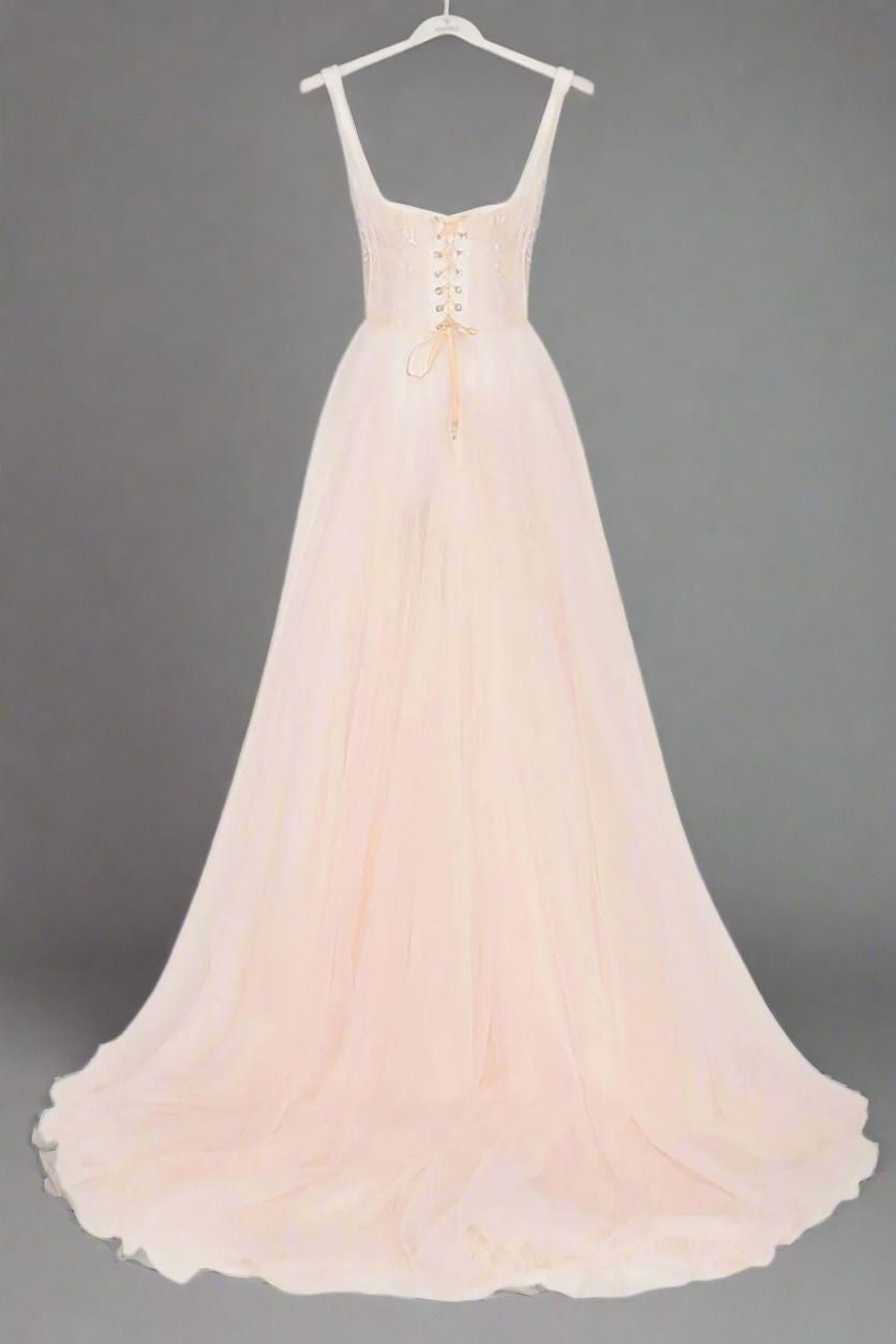 BAck view of baby pink formal party gown with spaghetti straps and sweep train