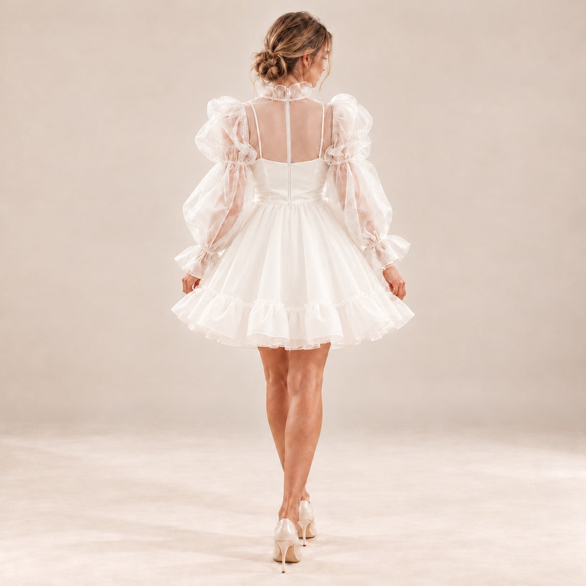 Back of ALLANAH short wedding dress with a sheer upper panel, centre zipper and ruffled mini skirt.