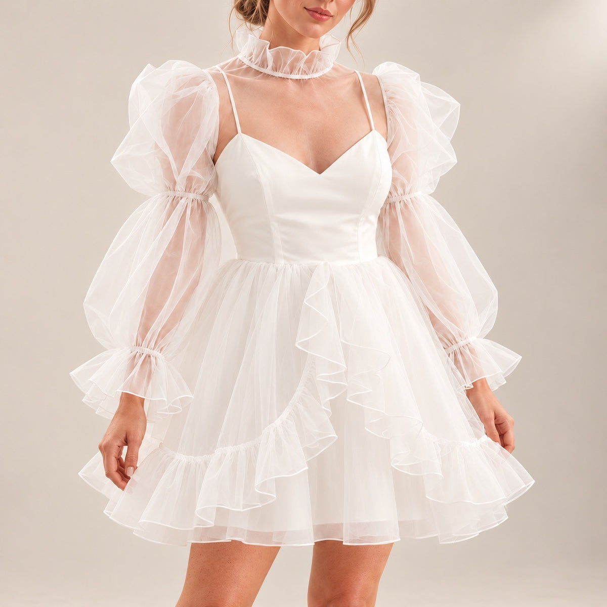 Close-up of ALLANAH wedding dress showing the fitted V-neck bodice, sheer long sleeves and cascading skirt ruffles.