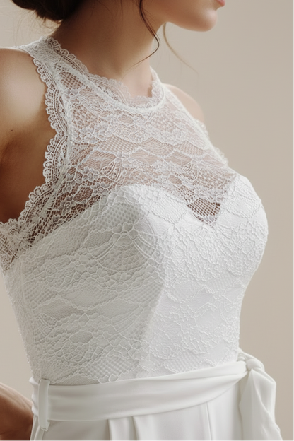 White lace top worn by a person with blurred background