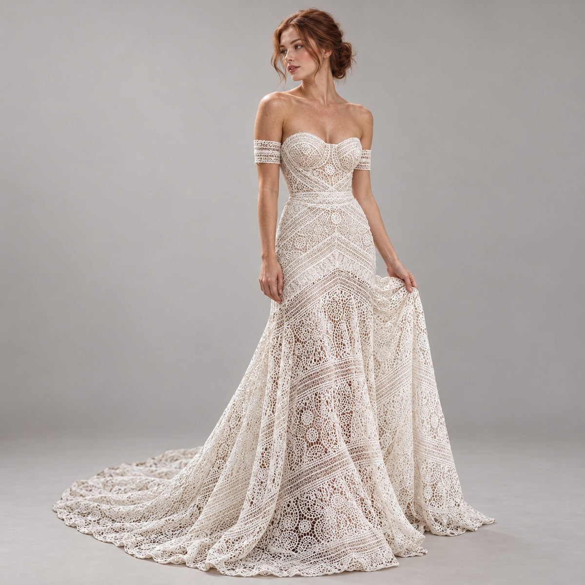 An off-the-shoulder lace wedding gown with a sweetheart neckline, fitted bodice, and full skirt with a train, shown on a model against a neutral gray studio background.