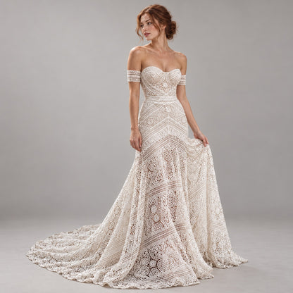 An off-the-shoulder lace wedding gown with a sweetheart neckline, fitted bodice, and full skirt with a train, shown on a model against a neutral gray studio background.