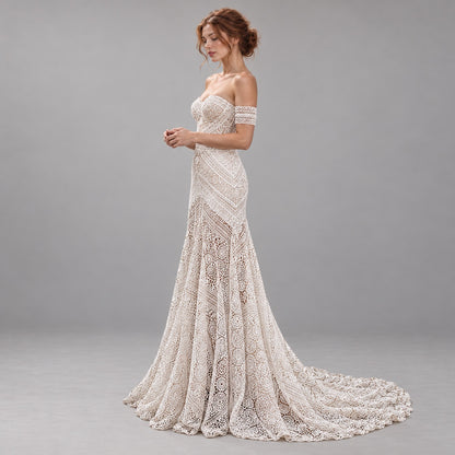 An off-the-shoulder lace wedding gown with a sweetheart neckline, fitted bodice, and dramatic train, shown on a model against a neutral gray studio background.