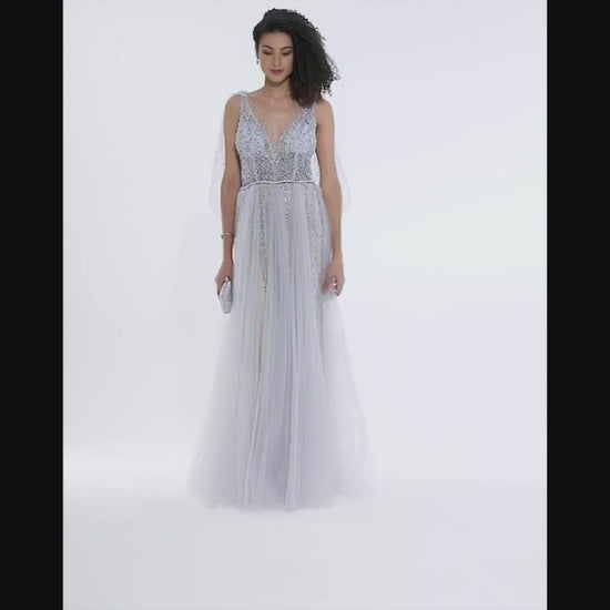 Woman with afro hairstyle twirling in blush silver A-line wedding gown with beaded bodice