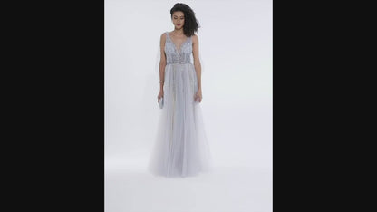 Woman with afro hairstyle twirling in blush silver A-line wedding gown with beaded bodice