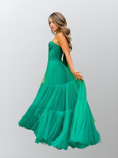 Side close-up of the tiered green tulle detail on the Raegan evening gown.
