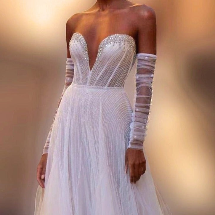 Bride showcasing pearl and ruched tulle detachable sleeves