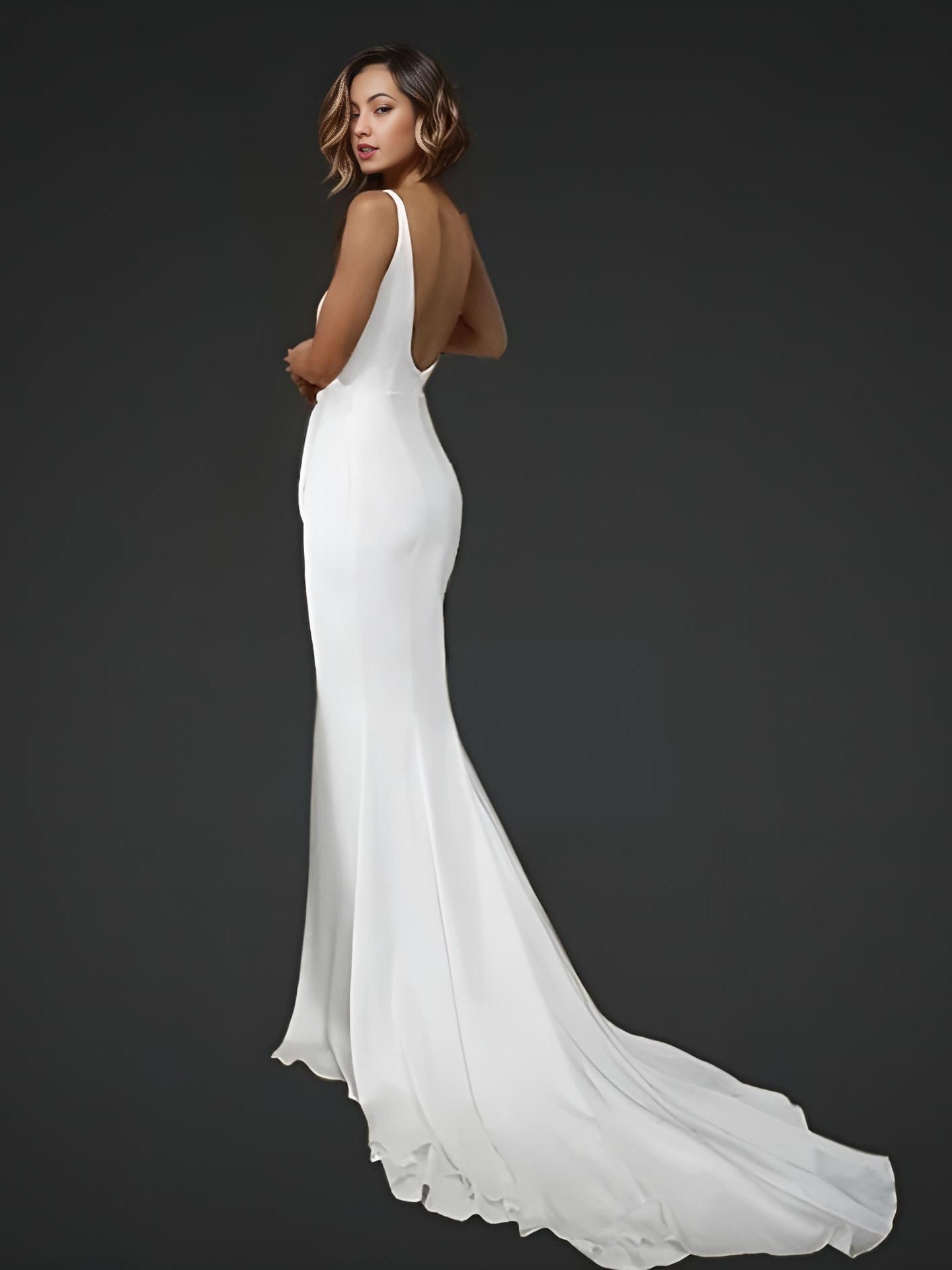 Woman in bridal gown featuring a backless design and train