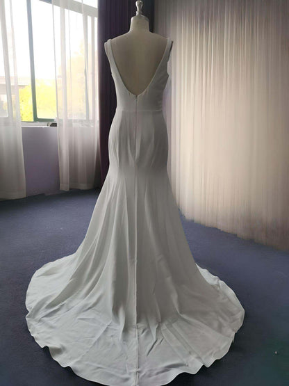 Showcase of bridal dress featuring a backless design with sweep train