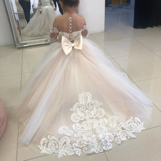 Girl showing MARA custom-made flower girl dress with lace skirt
